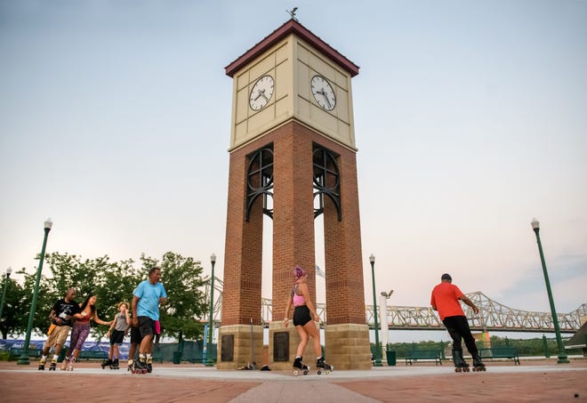 Skaters with the Central Illinois Roller Skaters circle the clock tower on the Peoria riverfront during their weekly gathering.