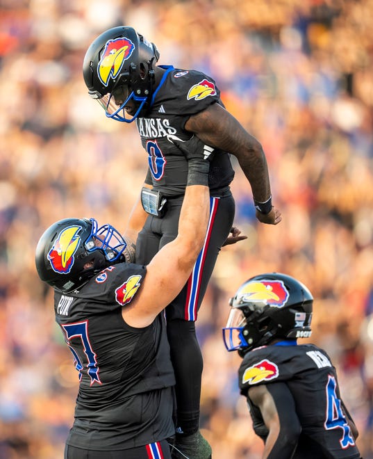 Sep 8, 2023; Lawrence, Kansas, USA; Kansas Jayhawks quarterback Jalon Daniels (6) celebrates with offensive lineman Dominick Puni (67) after a touchdown against the Illinois Fighting Illini during the first half at David Booth Kansas Memorial Stadium. Mandatory Credit: Jay Biggerstaff-USA TODAY Sports