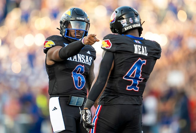 Sep 8, 2023; Lawrence, Kansas, USA; Kansas Jayhawks quarterback Jalon Daniels (6) celebrates with running back Devin Neal (4) after a touchdown against the Illinois Fighting Illini during the first half at David Booth Kansas Memorial Stadium. Mandatory Credit: Jay Biggerstaff-USA TODAY Sports
