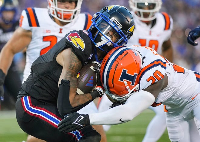 Sep 8, 2023; Lawrence, Kansas, USA; Kansas Jayhawks wide receiver Quentin Skinner (0) is tackled by Illinois Fighting Illini defensive back Tyler Strain (20) during the first half at David Booth Kansas Memorial Stadium. Mandatory Credit: Jay Biggerstaff-USA TODAY Sports