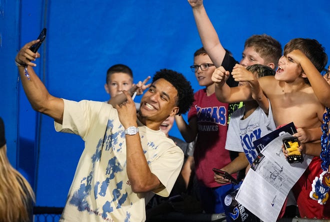 Sep 8, 2023; Lawrence, Kansas, USA; Kansas Jayhawks basketball player Kevin McCullar takes a photo with fans during the second half against the Illinois Fighting Illini at David Booth Kansas Memorial Stadium. Mandatory Credit: Jay Biggerstaff-USA TODAY Sports