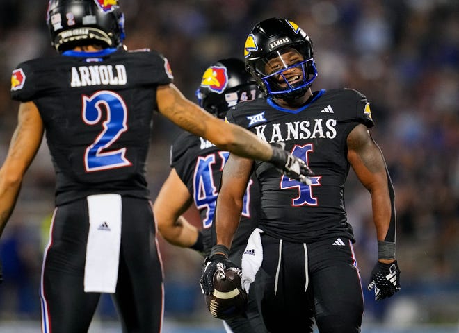 Sep 8, 2023; Lawrence, Kansas, USA; Kansas Jayhawks running back Devin Neal (4) reacts after a first down against the Illinois Fighting Illini during the second half at David Booth Kansas Memorial Stadium. Mandatory Credit: Jay Biggerstaff-USA TODAY Sports