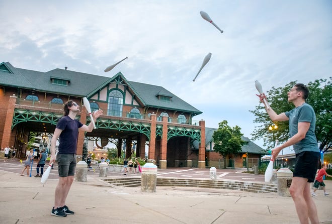 Kyle Wilfinger, left, of East Peoria and Kyle Boyer of Normal show off their juggling skills uring a weekly gathering of the Heart of Illinois Hoopers on the grounds of the Gateway Building on the Peoria riverfront. The pair are both veterans of the Illinois State University Gamma Phi Circus.