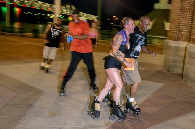 Roller skaters enjoy an evening skate around the clock tower during a weekly gathering of the Central Illinois Roller Skaters on the Peoria riverfront.