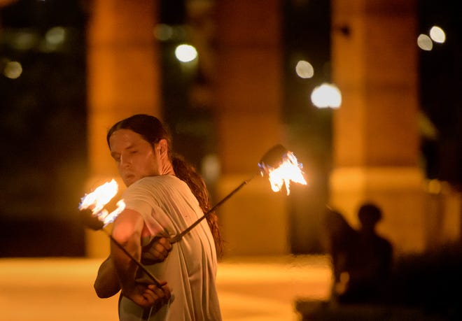 Dave Combs of East Peoria shows his skill with fire poi during a weekly gathering of the Heart of Illinois Hoopers at the Gateway Building on the Peoria riverfront.