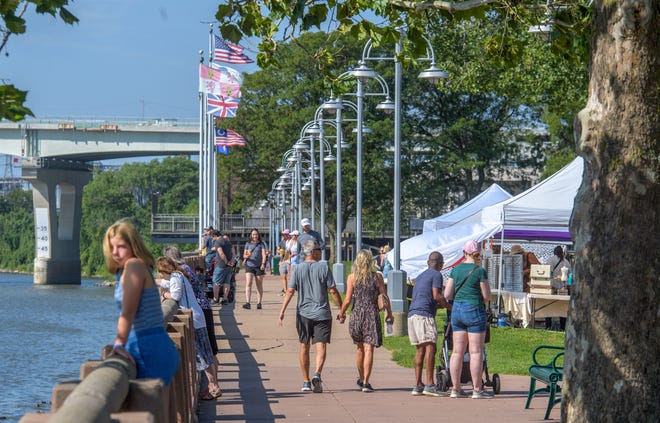 A crowd enjoys the Riverfront Market along the shoreline of the Illinois River in Peoria.