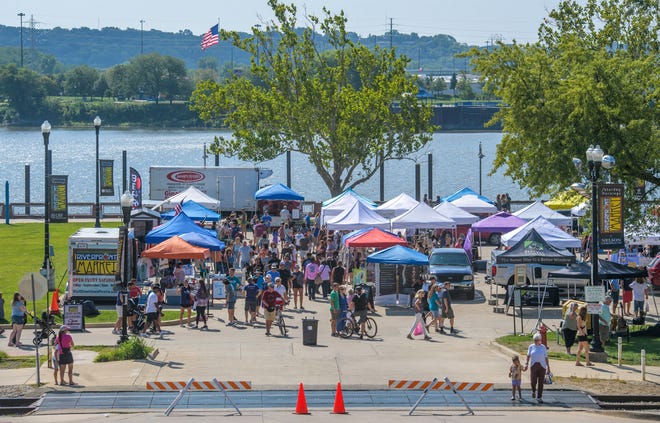 A crowd fills the parking lot of River Station for the weekly Riverfront Market in Peoria.