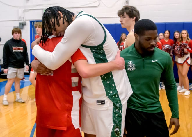 Richwoods' Lathan Sommerville hugs a Morton player after the Knights defeated the Potters 56-53 for the Class 3A Limestone Regional basketball title Friday, Feb. 23, 2024 in Bartonville.