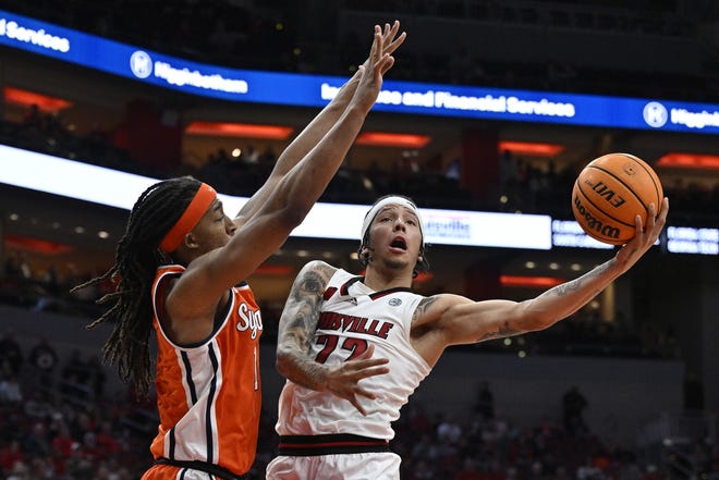 Mar 2, 2024; Louisville, Kentucky, USA; Louisville Cardinals guard Tre White (22) shoots against Syracuse Orange forward Maliq Brown (1) during the second half at KFC Yum! Center. Syracuse defeated Louisville 82-76. Mandatory Credit: Jamie Rhodes-USA TODAY Sports