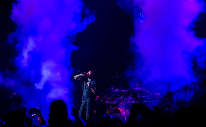 Steam is bathed in blue stage lights as Christian rapper Lecrae performs during the Winter Jam 2024 tour Thursday, March 14, 2024 at the Peoria Civic Center.