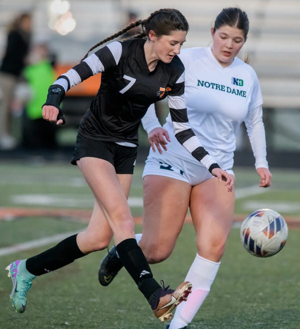 Washington's Tori Aberle, left, and Peoria Notre Dame's Hannah Daly chase the ball in the first period of their girls soccer match Tuesday, March 19, 2024 in Washington. The Irish defeated the Panthers 2-0.