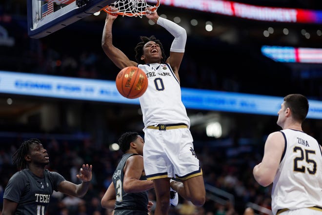 Mar 12, 2024; Washington, D.C., USA; Notre Dame Fighting Irish forward Carey Booth (0) dunks the ball as Georgia Tech Yellow Jackets forward Baye Ndongo (11) looks on in the second half at Capital One Arena. Mandatory Credit: Geoff Burke-USA TODAY Sports
