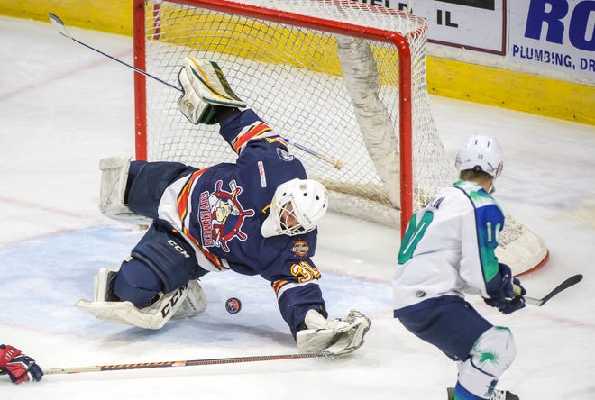 Peoria goaltender Nick Latinovich falls on the puck, stopping a shot from Pensacola's Garrett Milan in the second period of Game 2 of the first round of the SPHL playoffs Saturday, April 13, 2024 at the Peoria Civic Center. The Rivermen advanced to the semifinals with a 6-1 victory.