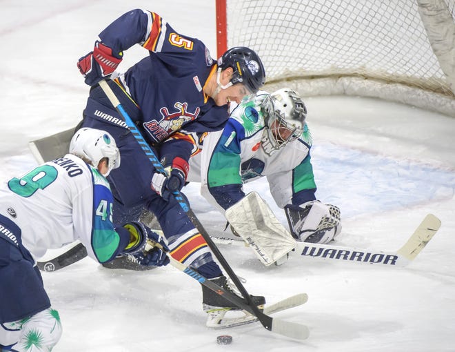 Peoria's Cale List tries to get control of the puck as Pensacola goaltender Stephen Mundinger and Ivan Bondarenko try to stop him in the first period of Game 2 of the first round of the SPHL playoffs Saturday, April 13, 2024 at the Peoria Civic Center. The Rivermen advanced to the semifinals with a 6-1 victory.