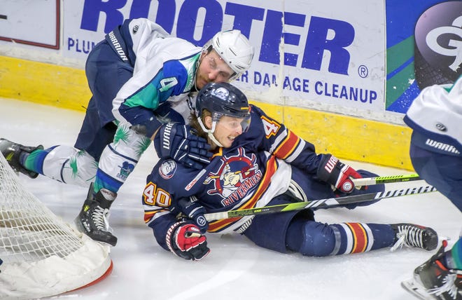 Peoria's JM Piotrowski (40) and Pensacola's Troy Button fall to the ice while chasing the puck in the first period of Game 2 of the first round of the SPHL playoffs Saturday, April 13, 2024 at the Peoria Civic Center. The Rivermen advanced to the semifinals with a 6-1 victory.