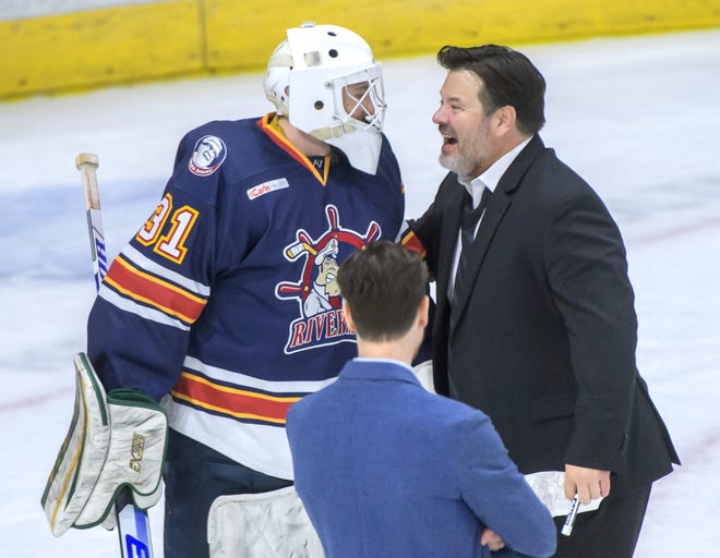 Peoria Rivermen head coach Jean-Guy Trudel, right, celebrates with goaltender Nick Latinovich after Game 2 of the first round of the SPHL playoffs Saturday, April 13, 2024 at the Peoria Civic Center. The Rivermen advanced to the semifinals with a 6-1 victory.