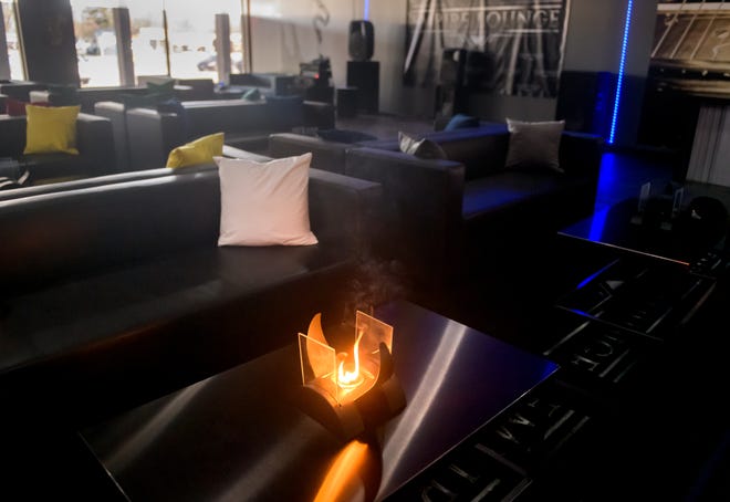 A tabletop flame adds some ambience to the casual and relaxed sofa seating of the new Empire Lounge at 3033 N. Sterling Avenue in Peoria.