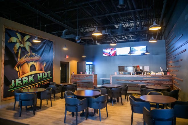 John Sims, owner of the Jerk Hut, a Caribbean restaurant formerly in the Campustown Shopping Center, now runs the eatery in the back of his new club Empire Lounge in the Wardcliffe Shopping Center in Peoria.