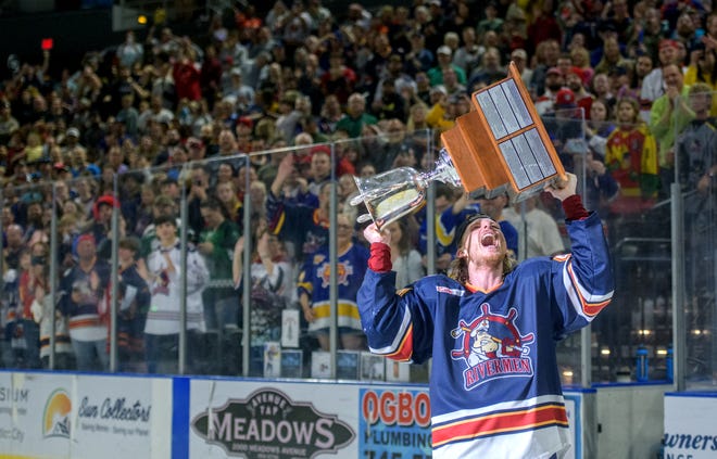 Peoria's JM Piotrowski hoists the President's Cup as a large crowd of Rivermen fans cheer after their 5-1 victory over the Huntsville Havoc in the deciding game of the SPHL President's Cup finals Sunday, April 28, 2024 at the Peoria Civic Center.
