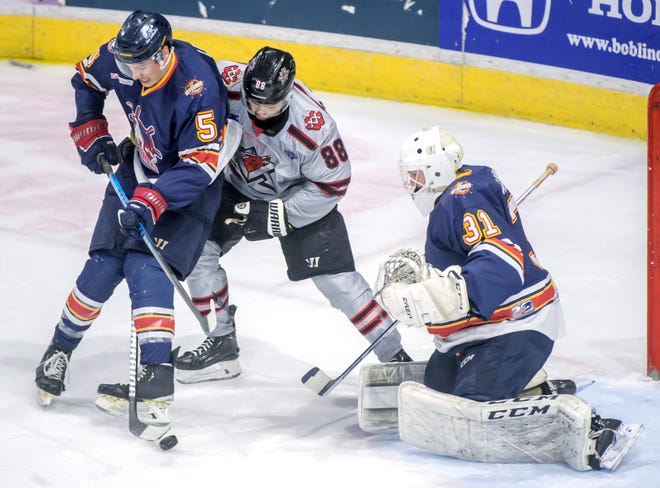 Peoria's Cale List (5) battles Huntsville's Phil Elgstam (88) in front of goaltender Nick Latinovich in the second period of the deciding game of the SPHL President's Cup finals Sunday, April 28, 2024 at the Peoria Civic Center.