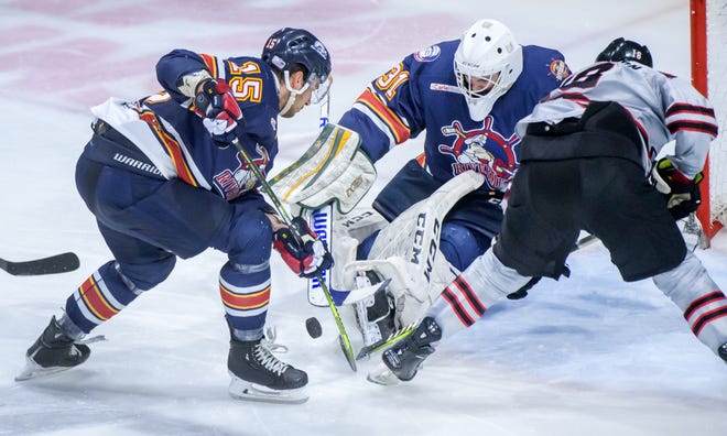 Peoria goaltender Nick Latinovich (31) and Renat Dadadzhanov (15) stop Huntsville's Eric Henderson at the net in the second period of the deciding game of the SPHL President's Cup finals Sunday, April 28, 2024 at the Peoria Civic Center.