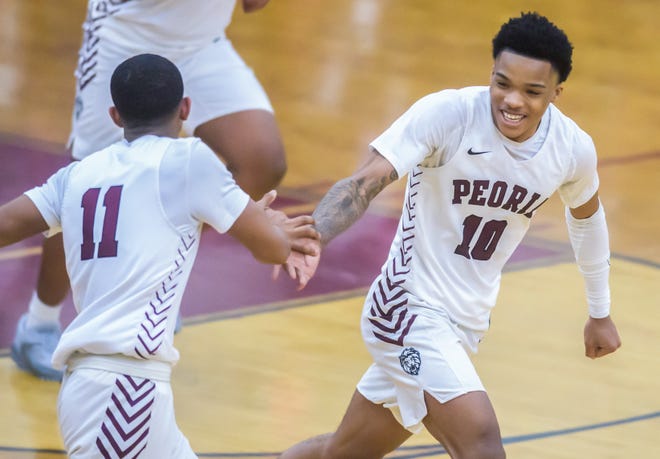 Peoria High's MikeQuese Taylor (10) smiles after celebrating a score against Manual during a Feb. 14, 2023 high school basketball game in Peoria. Taylor was shot and killed in Peoria on April 30, 2024.